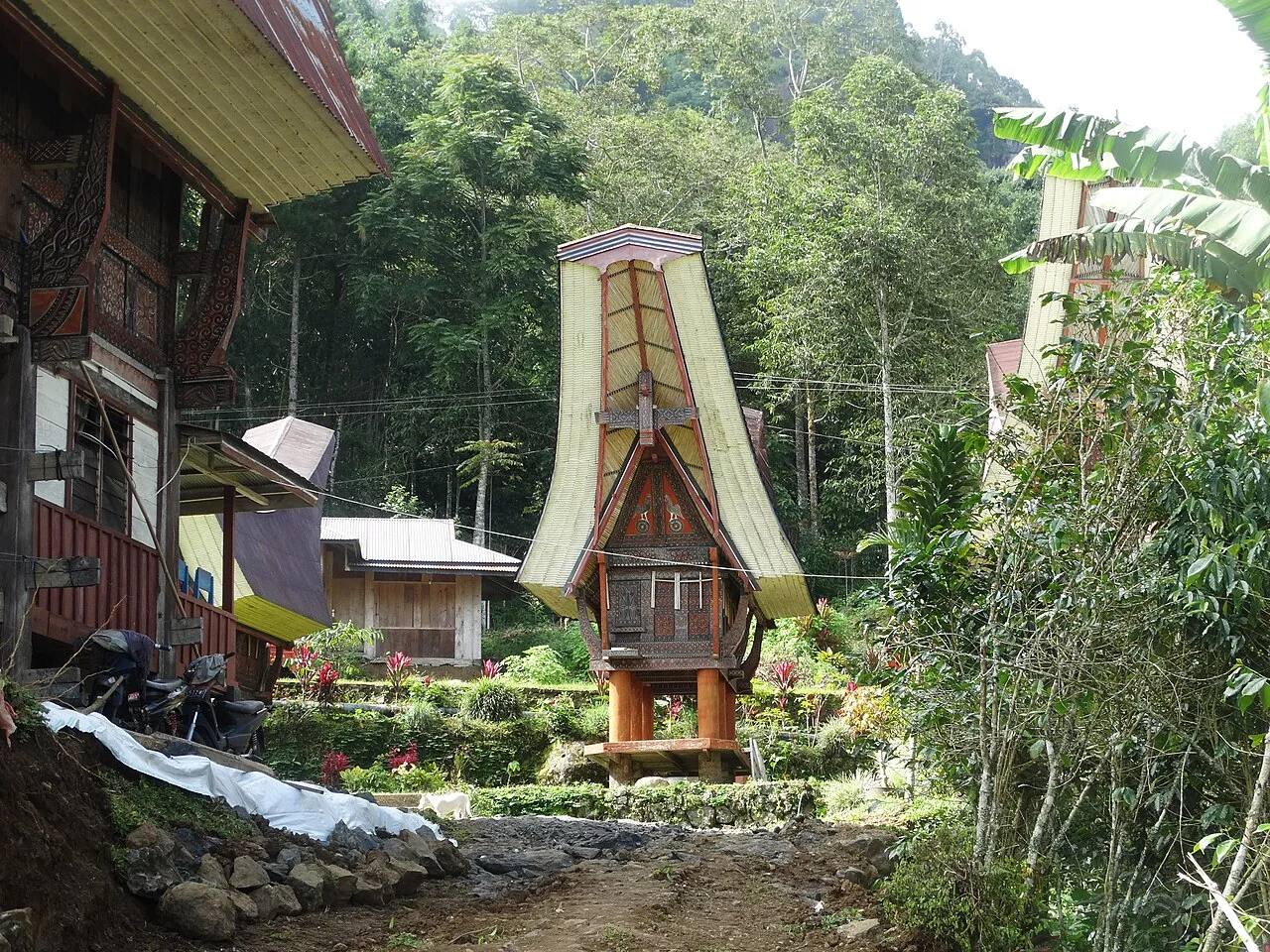 A traditional tongkonan house in a leafy village near Rantepao